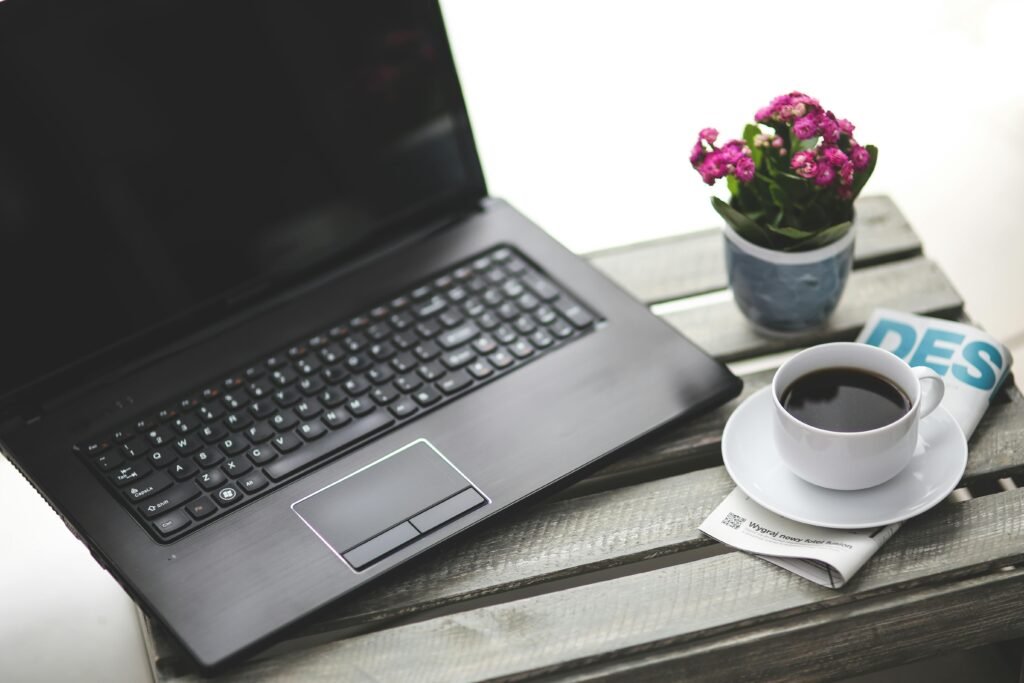 A professional minimalist desk with a laptop and coffee representing affiliate marketing without a personal brand on danijacob.com.