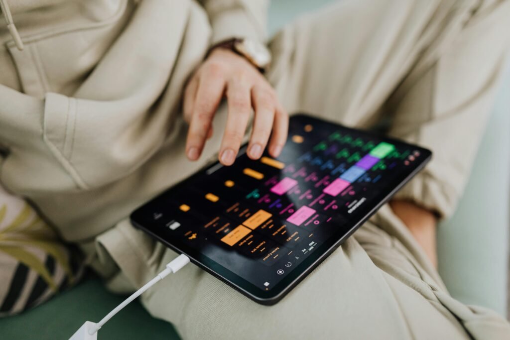 Hands using a tablet to manage aesthetic Pinterest pins that drive viral traffic to danijacob.com anonymously.