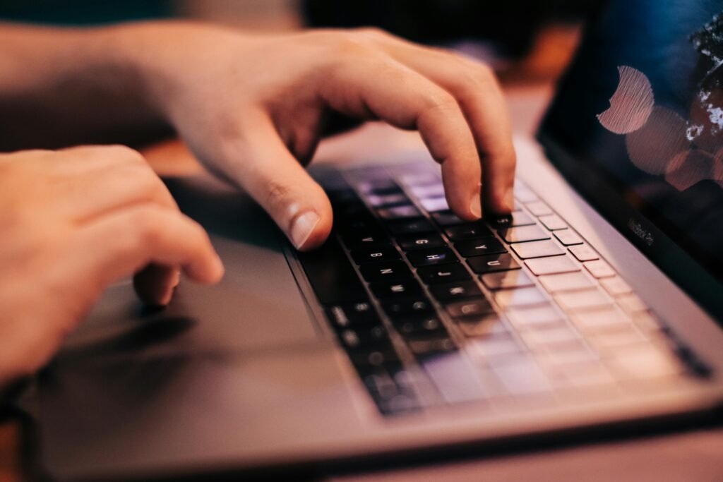 A close-up of a content creator's hands typing, symbolizing the deep work required in affiliate marketing for introverts.