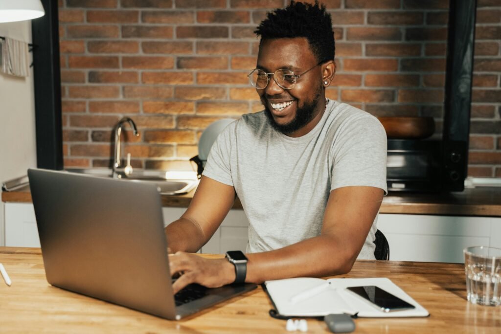 A high-energy workspace with a coffee cup, a notebook with 'Weekend Goal' written on it, and a laptop screen showing a design in progress, representing the **high-demand digital products** creation sprint.