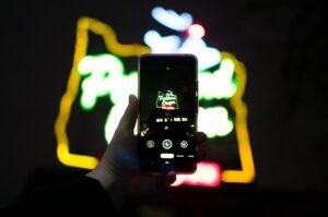 A high-quality close up of a hand holding a smartphone with glowing digital elements representing the real use of affiliate marketing apps for android on danijacob.com.