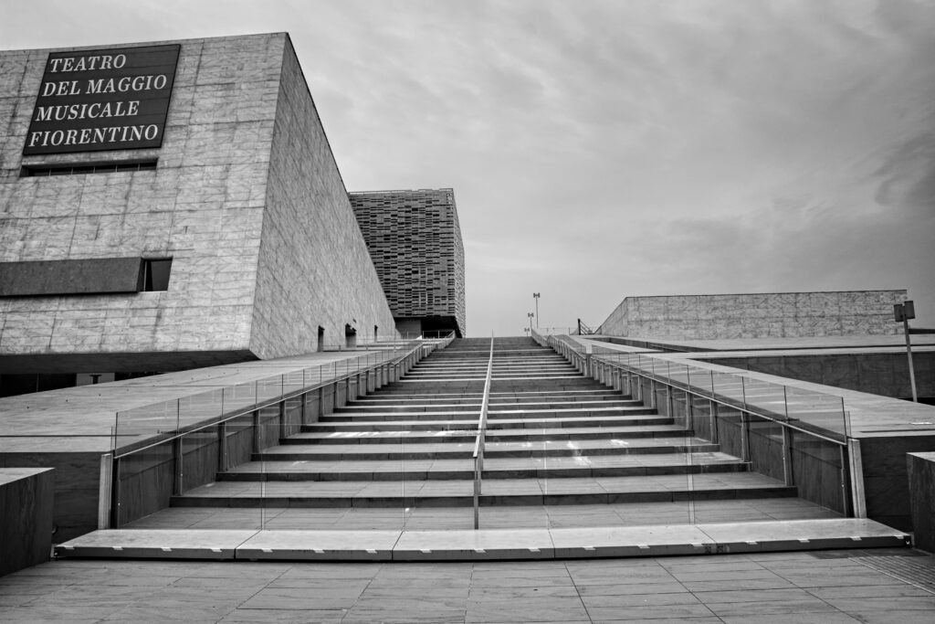 Minimalist white stairs representing the step-by-step growth when you sell no-code database templates for high-ticket profit.